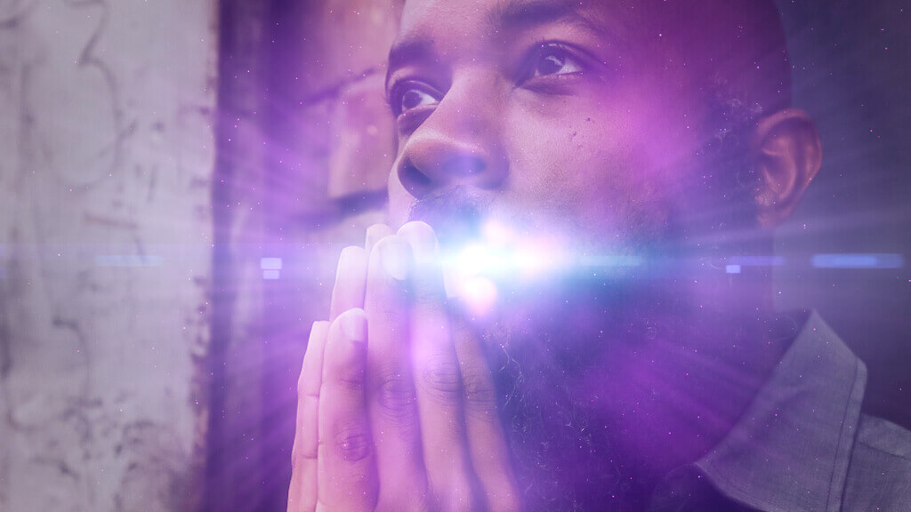 jclay with praying hands and a light