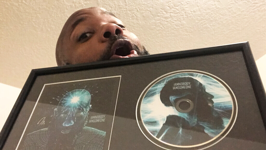 jclay holding album plaque for iamnobody iamsomeone