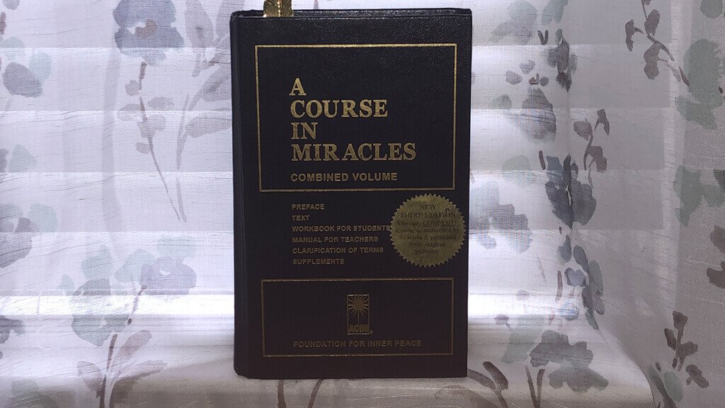 A Course In Miracles book on a window sill